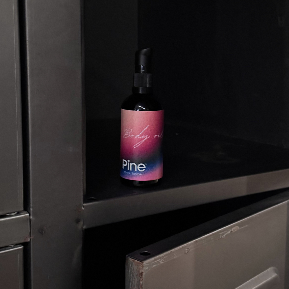 
                  
                    Bottle of Pine body oil on a dark surface
                  
                